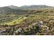 Gorgeous aerial view of a sprawling desert community with lush golf courses and stunning mountain backdrops at 9894 E Miramonte Dr, Scottsdale, AZ 85262