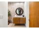 Elegant powder room featuring granite countertop, vessel sink, and decorative round mirror at 9894 E Miramonte Dr, Scottsdale, AZ 85262