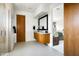 Bright bathroom featuring wood cabinets, granite countertops and a walk-in glass shower, with a view to the bedroom at 9894 E Miramonte Dr, Scottsdale, AZ 85262