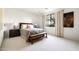 Cozy bedroom with a comfortable bed, a bench, and natural light from the window at 9894 E Miramonte Dr, Scottsdale, AZ 85262