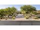 Attractive desert home with manicured landscaping, decorative rocks, and a brick driveway at 9894 E Miramonte Dr, Scottsdale, AZ 85262