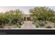 Charming desert home with beautiful trees, native landscaping, and a brick driveway at 9894 E Miramonte Dr, Scottsdale, AZ 85262