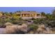 Beautiful desert home with covered patio highlighting the serene and natural desert landscape at 9894 E Miramonte Dr, Scottsdale, AZ 85262