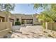 Inviting desert home with brick driveway, complemented by beautiful trees, and desert landscaping at 9894 E Miramonte Dr, Scottsdale, AZ 85262