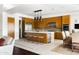Stylish kitchen boasts wood cabinets, island with seating, stainless steel appliances, and wine refrigerator at 9894 E Miramonte Dr, Scottsdale, AZ 85262