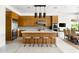 Contemporary kitchen featuring wood cabinets, a large island, stainless steel appliances, and tile flooring at 9894 E Miramonte Dr, Scottsdale, AZ 85262