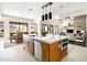 Spacious kitchen features wood cabinets, a large island, stainless steel appliances, and an open concept design at 9894 E Miramonte Dr, Scottsdale, AZ 85262