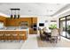 Modern kitchen with wood cabinets, large island, stainless steel appliances and adjacent dining area at 9894 E Miramonte Dr, Scottsdale, AZ 85262