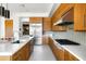 Gourmet kitchen features wood cabinets, stainless steel appliances, gas range, and quartz countertops at 9894 E Miramonte Dr, Scottsdale, AZ 85262