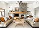 Beautiful living room with a stone fireplace, comfortable sofas, and stylish decor at 9894 E Miramonte Dr, Scottsdale, AZ 85262