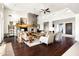Open-concept living room with hardwood floors, a stone fireplace, and abundant natural light at 9894 E Miramonte Dr, Scottsdale, AZ 85262
