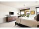 Bright main bedroom featuring a walk-out patio, a mounted television and luxury finishes at 9894 E Miramonte Dr, Scottsdale, AZ 85262