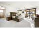 Bright main bedroom with plush carpeting, sliding glass door with mountain views, and ensuite bath at 9894 E Miramonte Dr, Scottsdale, AZ 85262