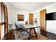Bright office space featuring a large rustic desk, comfortable seating and a view to the rest of the house at 9894 E Miramonte Dr, Scottsdale, AZ 85262