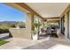 Covered patio with built in grill and bar, dining table, and desert views at 9894 E Miramonte Dr, Scottsdale, AZ 85262