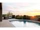 Poolside view with outdoor kitchen, desert foliage, and scenic desert sunrise at 9894 E Miramonte Dr, Scottsdale, AZ 85262