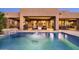 Luxurious outdoor living with a pool, waterfall feature, comfortable seating, and desert views at 9894 E Miramonte Dr, Scottsdale, AZ 85262