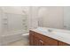This bathroom features a shower and tub combo and modern wood cabinetry at 10502 W Bronco Trl, Peoria, AZ 85383
