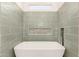 Close-up of the soaking tub with a unique tile backsplash in the bath at 10502 W Bronco Trl, Peoria, AZ 85383