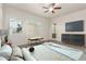 Staged bedroom features neutral carpet, ceiling fan, and a door leading to outdoor space at 10502 W Bronco Trl, Peoria, AZ 85383