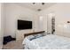 Bright bedroom featuring neutral walls, carpet flooring, and a dresser with mounted television at 10502 W Bronco Trl, Peoria, AZ 85383