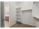 Walk-in closet features built-in shelving and rod for ample storage at 10502 W Bronco Trl, Peoria, AZ 85383