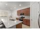 Bright kitchen features a quartz countertop island, modern appliances, and wood cabinets at 10502 W Bronco Trl, Peoria, AZ 85383