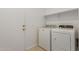 Bright laundry room features modern washer and dryer and storage shelf at 10502 W Bronco Trl, Peoria, AZ 85383