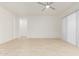 An empty living room featuring tile floors and sliding glass doors at 10502 W Bronco Trl, Peoria, AZ 85383