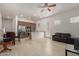 Open-concept living area with tiled floors seamlessly connects the kitchen and living spaces at 10502 W Bronco Trl, Peoria, AZ 85383