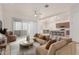 A modern living room with sleek furniture open to a kitchen with a long island at 10502 W Bronco Trl, Peoria, AZ 85383