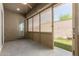 Covered patio with screens offers seamless indoor-outdoor living and a glimpse of the backyard at 10502 W Bronco Trl, Peoria, AZ 85383