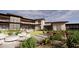 Expansive backyard with a fire pit, outdoor seating, lush landscaping, and a modern home in the background at 10772 E Canyon Cross Way, Scottsdale, AZ 85255