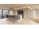 Modern bar area featuring sleek counter seating, a TV, light wood paneling, and contemporary lighting at 10772 E Canyon Cross Way, Scottsdale, AZ 85255