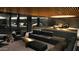 Luxury garage features plush seating, a unique bar area, and parking for multiple luxury vehicles at 10772 E Canyon Cross Way, Scottsdale, AZ 85255