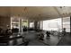 Well-equipped home gym with treadmills, weights, and a view of the car collection at 10772 E Canyon Cross Way, Scottsdale, AZ 85255