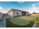 Wide angle photo of the artificial putting green and lush landscaping in the backyard at 11019 E Tiburon Ave, Mesa, AZ 85212