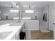 Sleek bathroom with a spacious walk-in shower, white marble style tiling, and a modern vanity at 11019 E Tiburon Ave, Mesa, AZ 85212