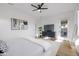Spacious bedroom with hardwood floors, modern ceiling fan, and access to a patio, blending comfort and style at 11019 E Tiburon Ave, Mesa, AZ 85212