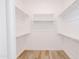 Spacious walk-in closet with built-in shelving and wood floors to keep all your belongings organized at 11019 E Tiburon Ave, Mesa, AZ 85212