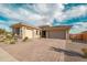 Charming single-story home with a well-maintained front yard and a paver driveway leading to an attached two-car garage at 11019 E Tiburon Ave, Mesa, AZ 85212