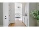 Bright hallway with wood floors, leading to the bedroom and a cabinet with counterspace at 11019 E Tiburon Ave, Mesa, AZ 85212