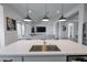 Contemporary kitchen with an open layout, features an island with a sink, stylish faucet, and seamless connection to the living space at 11019 E Tiburon Ave, Mesa, AZ 85212