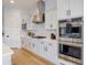 Elegant kitchen with stainless steel double oven, sleek white cabinetry, and a modern stovetop for gourmet cooking at 11019 E Tiburon Ave, Mesa, AZ 85212