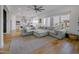 Spacious living room featuring an oversized sectional sofa, large windows, and an open layout to the kitchen at 11019 E Tiburon Ave, Mesa, AZ 85212