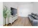 Well-lit living room with a TV, console, sofa, and tiled floors perfect for relaxation and entertainment at 11019 E Tiburon Ave, Mesa, AZ 85212