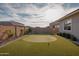 Backyard putting green features artificial turf, flag poles, and mature landscaping at 11019 E Tiburon Ave, Mesa, AZ 85212