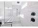 Walk-in shower with white marble tiling, a bench, and sleek fixtures at 11019 E Tiburon Ave, Mesa, AZ 85212