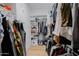 Organized walk-in closet with shelving, hanging rods, and secure storage, maximizing space and convenience at 11019 E Tiburon Ave, Mesa, AZ 85212