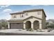 A charming two-story home features a two-car garage and front yard landscaping at 14394 W Calle Lejos --, Surprise, AZ 85387